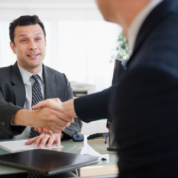 Businessmen shaking hands in office